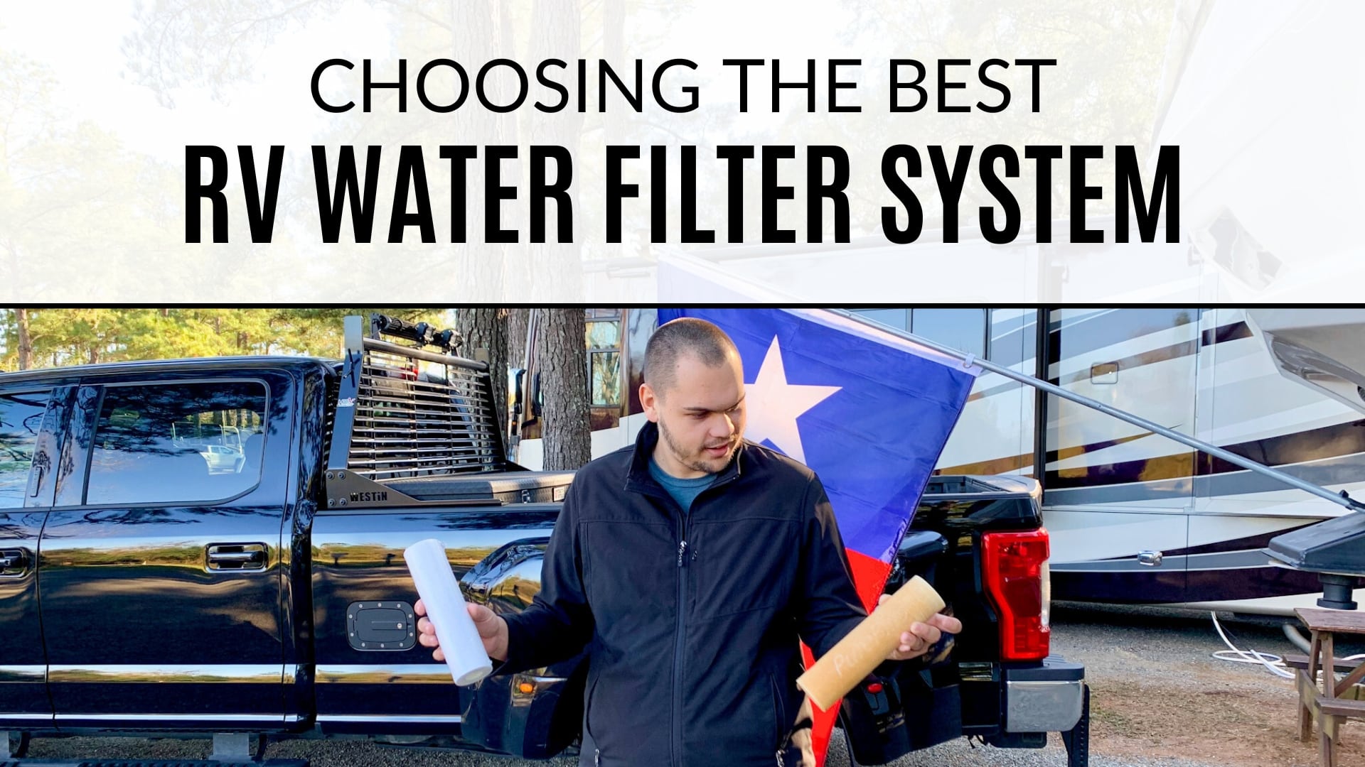 Philip wearing a black jacket holding two RV water filters. The filter on the left is brand new, white, and clean. The filter on the right is a used filter that's a dirty, light orange color. Behind Philip is a black pickup truck and a motorhome. The text at the top of the image says "Choosing the Best RV Water Filter System"