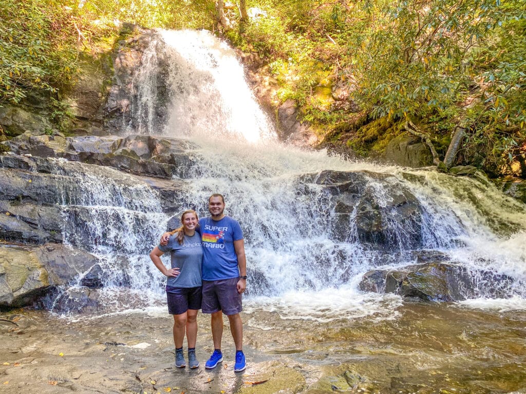 Couple standing in front of Laurel Falls in Smoky Mountains
