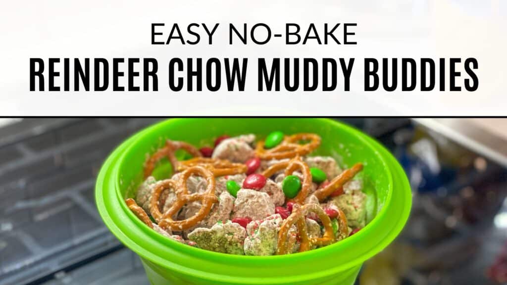 Green bowl sitting on stovetop containing Reindeer Chow with red and green M&M's and pretzels. Text on the image says "Easy No-Bake Reindeer Chow Muddy Buddies"
