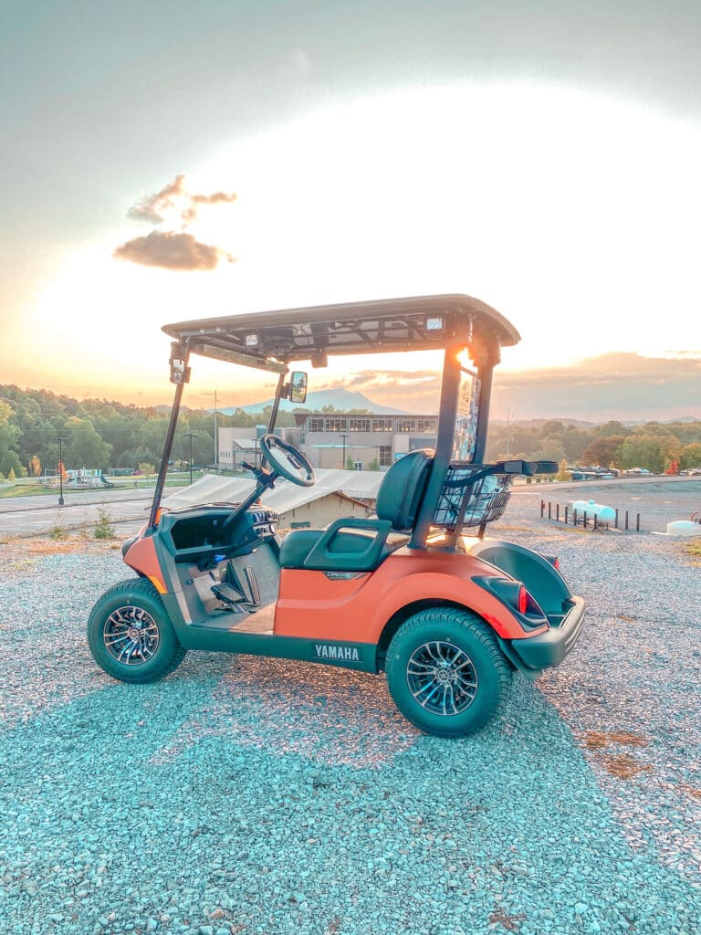 golf cart on hill at sunset