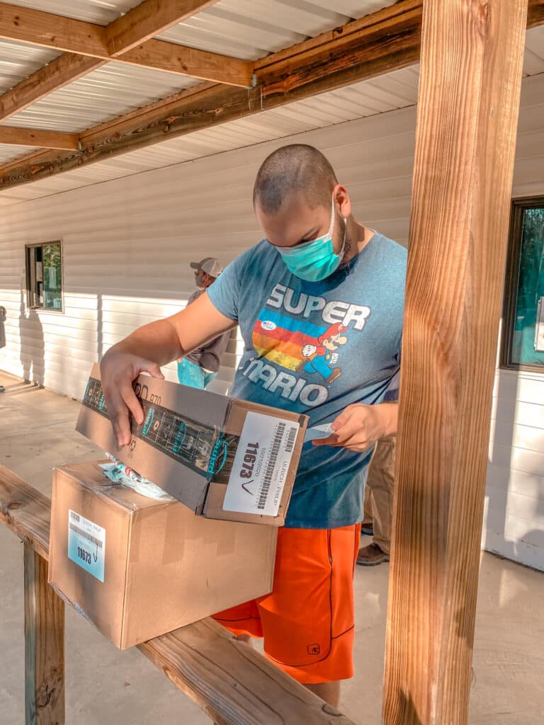 man picking up packages