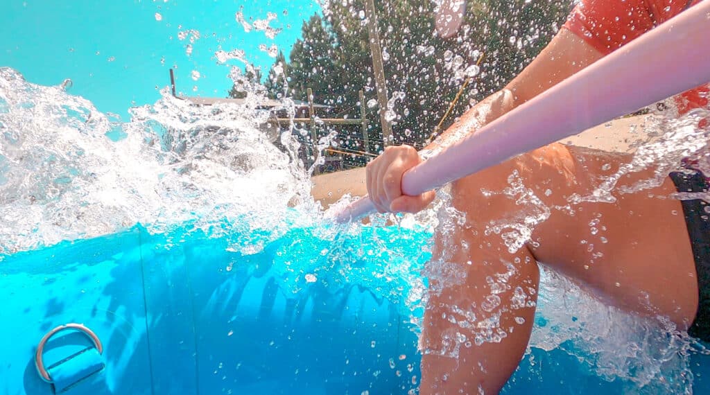 water splashing into raft woman holding paddle