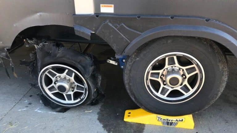 Blown out trailer tire being changed with help of Trailer Aid ramp