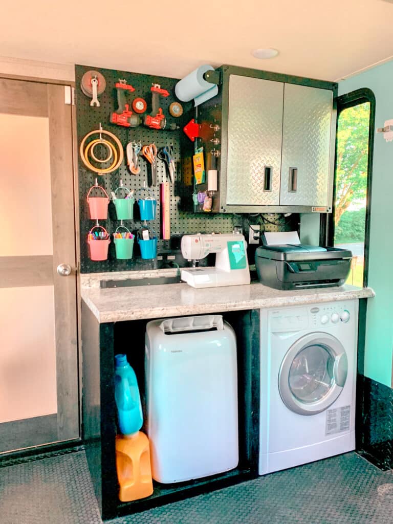RV Toy Hauler Garage with washer and pegboard organization