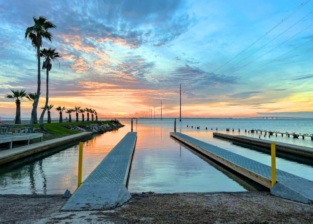 South Padre Island KOA boat ramps overlooking the bay with sun setting in the background