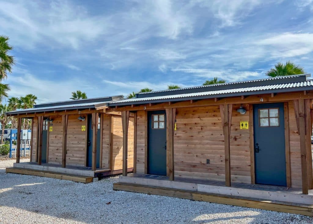 Wooden buildings with individual doors for restrooms in KOA campground