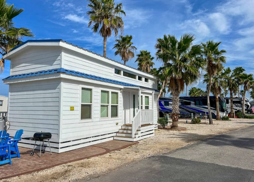 Tiny white cabin with blue roof at the South Padre KOA.