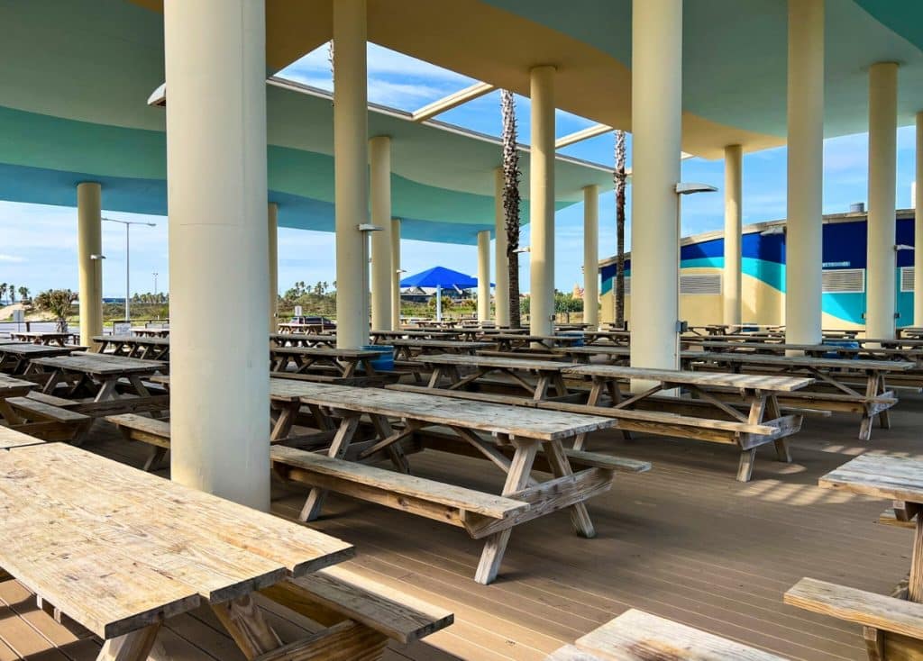 Picnic tables under a beachside pavilion in Isla Blanca RV Park