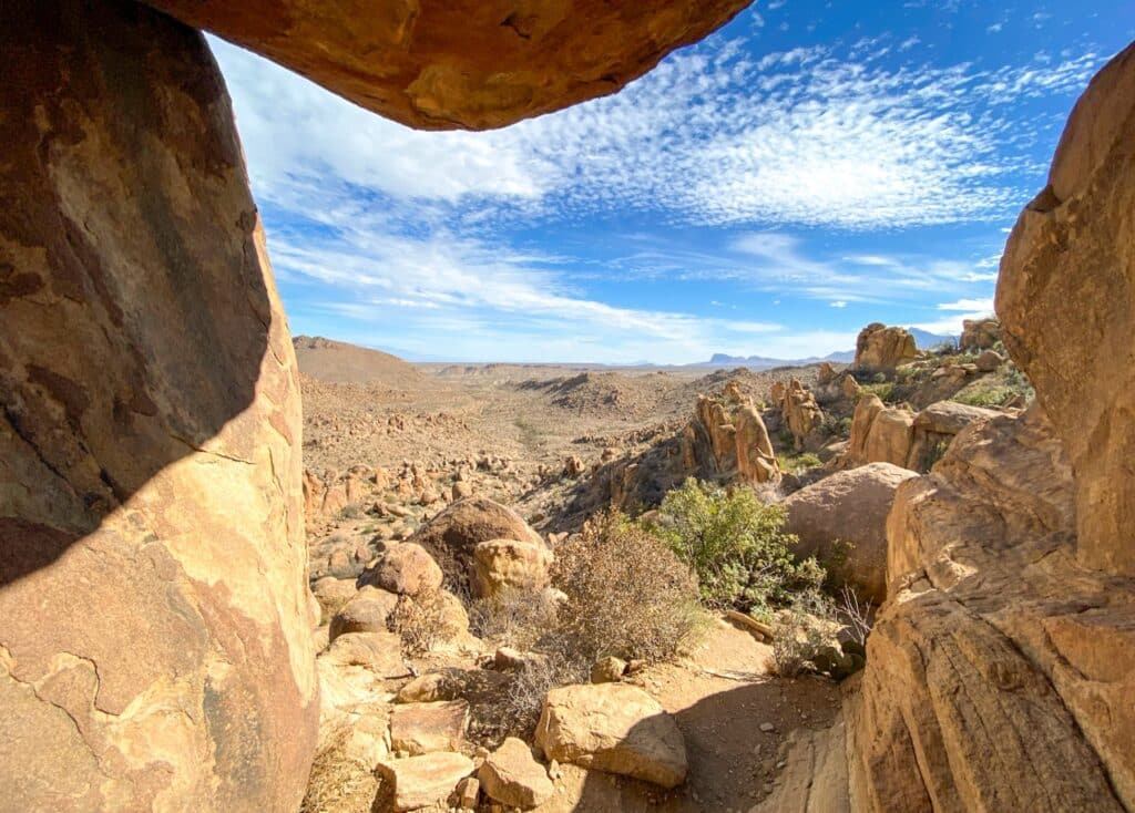 Photo was taken standing under Balanced Rock overlooking the desert on a warm sunny day.
