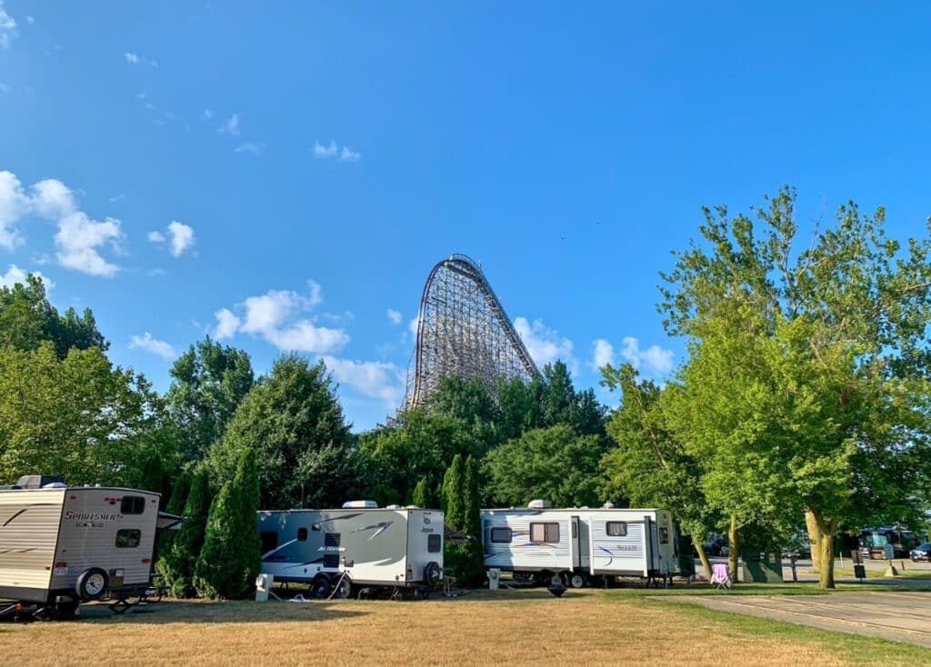 Travel trailers parked in campsites at the Cedar Point RV Campground overlooking the Steel Vengeance roller coaster.