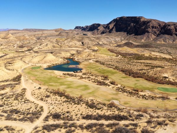 An aerial view of Black Jack's Crossing Golf Course with mountains surrounding the course and Big Bend National Park in the distance.