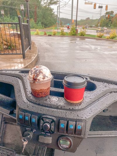 coffee in cup holders on golf cart
