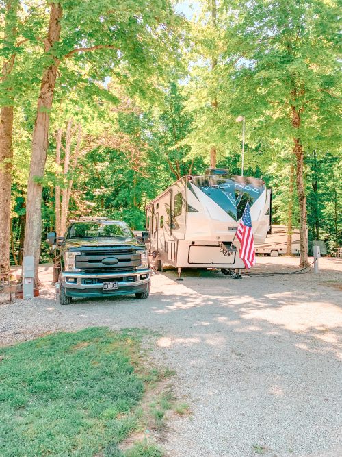 Truck and fifth wheel in wooded rv site