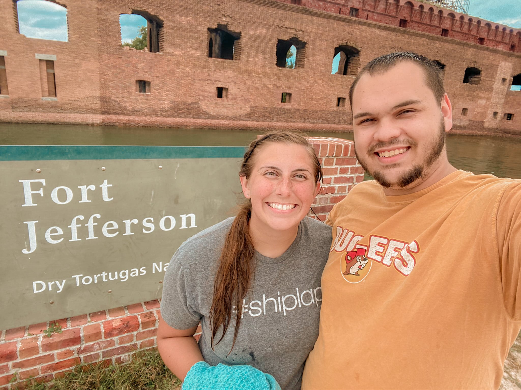 couple posing in front of Fort Jefferson sign Dry Tortugas