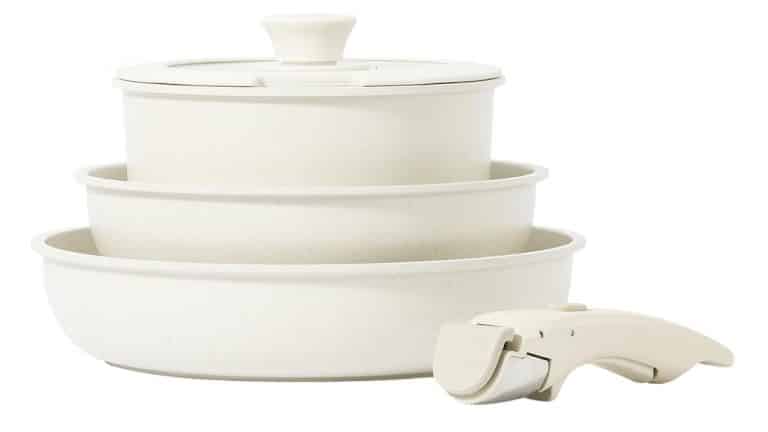 Cream colored nesting pots and pans with removable handle