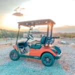 golf cart on hill at sunset