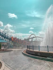 Rollercoaster going past water fountain