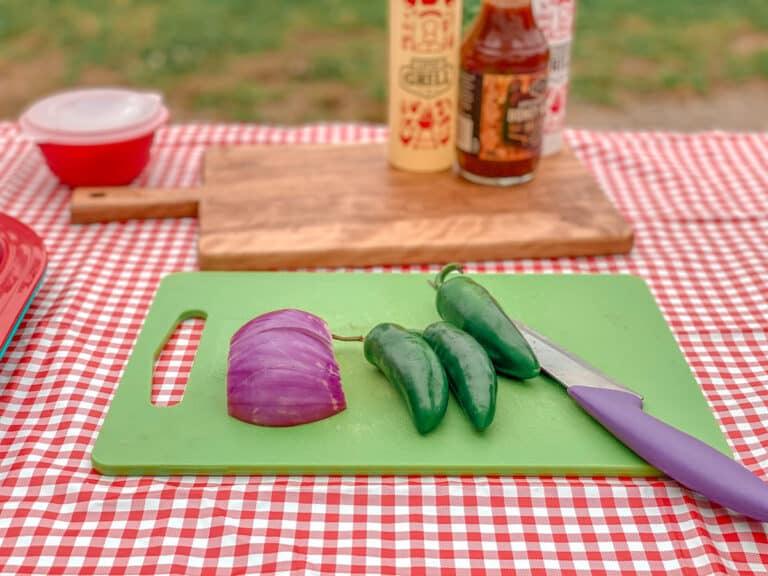 Jalapeños and red onion on cutting board