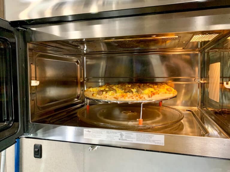 Breakfast pizza cooking inside an RV convection oven