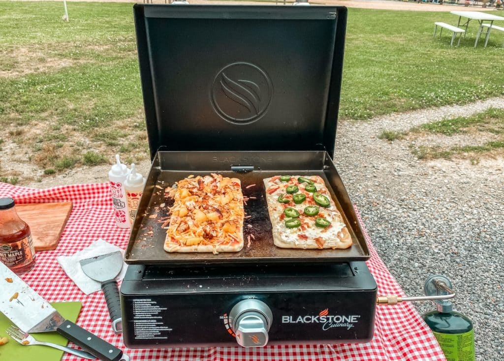 Single burner Blackstone griddle cooking flatbread pizzas