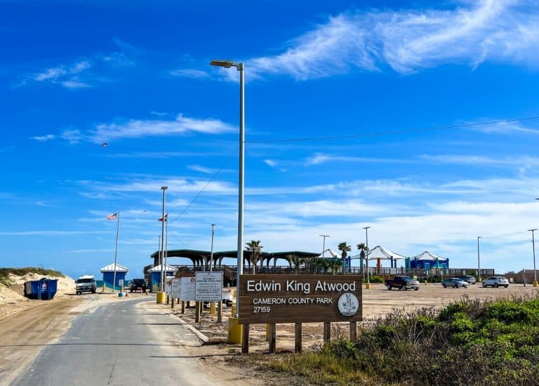 Entrance to Edwin King Atwood Park. Parking lot on right side and beach entrance to the left. Covered pavilion overlooking the beach is just behind the parking lot.