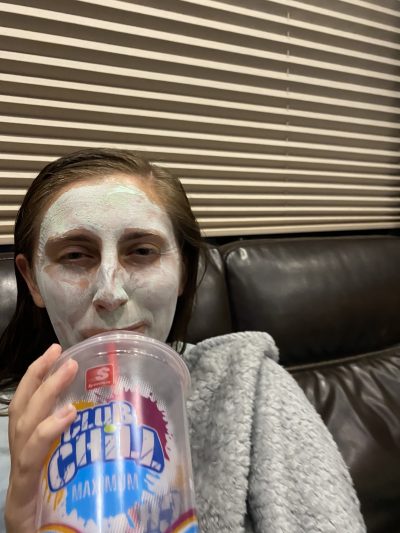 Megan drinking slushy and wearing face mask