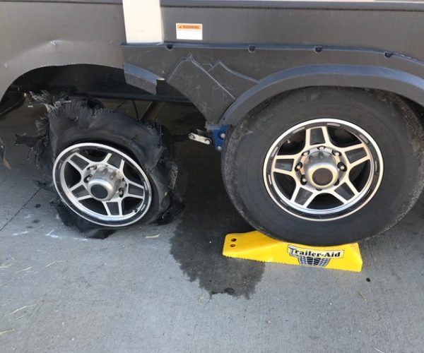 Blown out trailer tire being changed